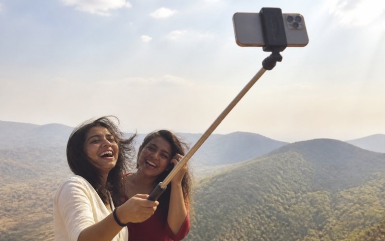 Selfie-Stick mit Smartphone am Aussichtspunkt